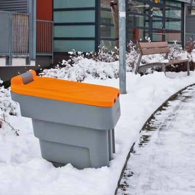 Streugutbehälter PE Fassungsvermögen Geschlossener Streugutbehälter aus PE im Schnee vor einem Gebäude